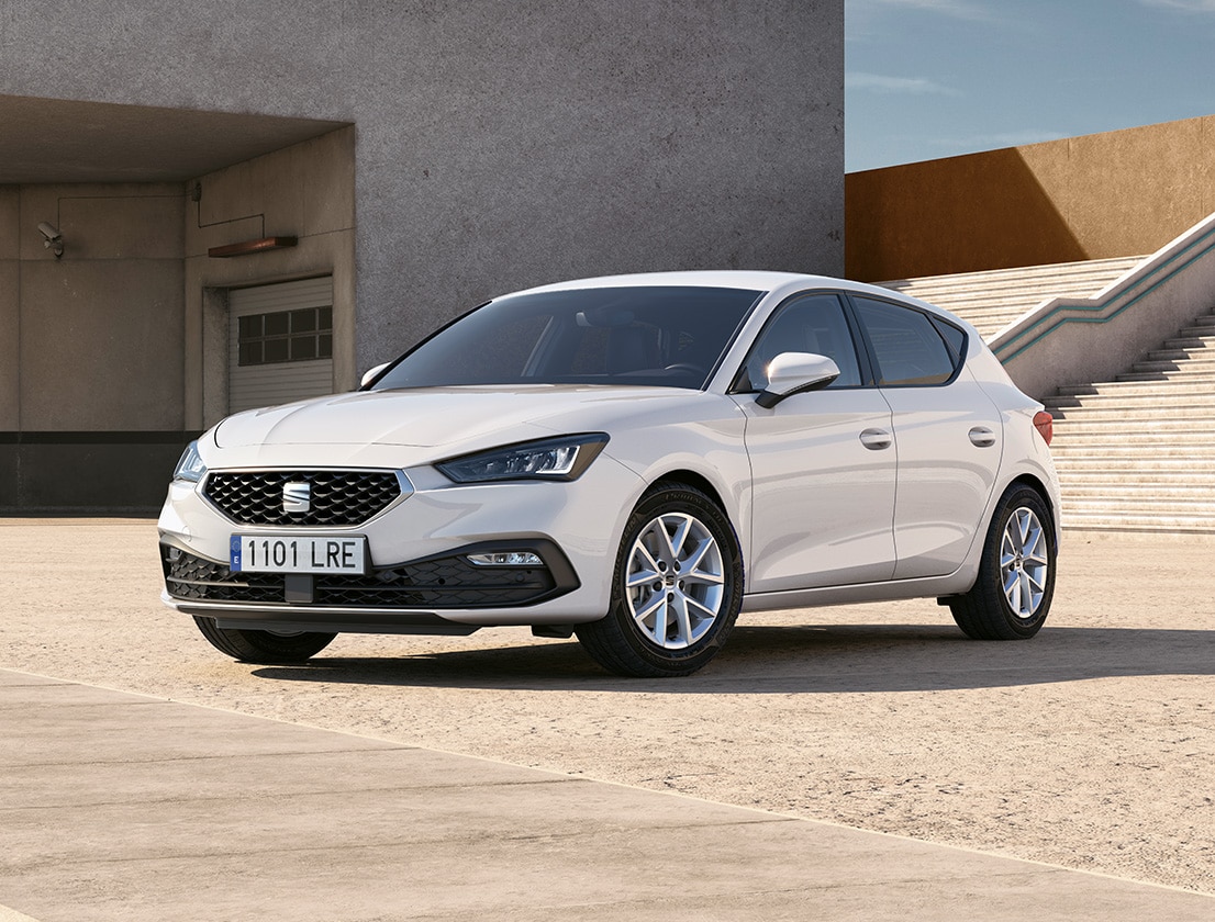 Rear view of the seat leon fr automatic car charging at a station, a new hatchback for 2025 in magnetic grey, complete with rear parking sensors and led headlights and taillights.