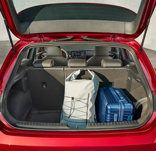 SEAT Leon hatchback 2025 plug in hybrid electric vehicle. Parked and charging outdoors, featuring spoke alloy wheels, interior ambient lighting and heated front seats for optimal comfort.