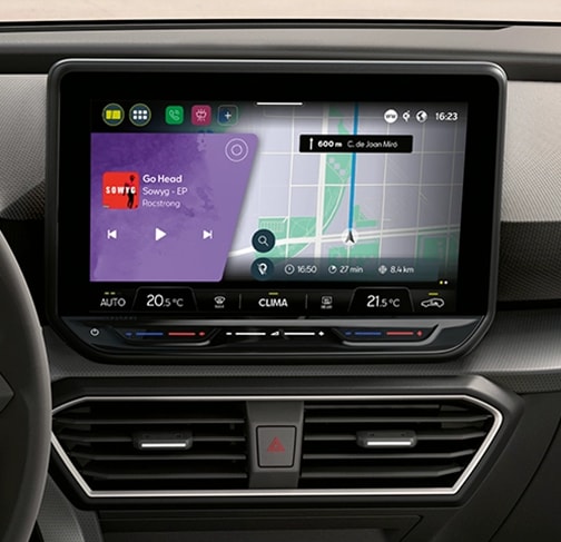 Rear view of the seat leon fr automatic car charging at a station, a new hatchback for 2025 in magnetic grey, complete with rear parking sensors and led headlights and taillights.