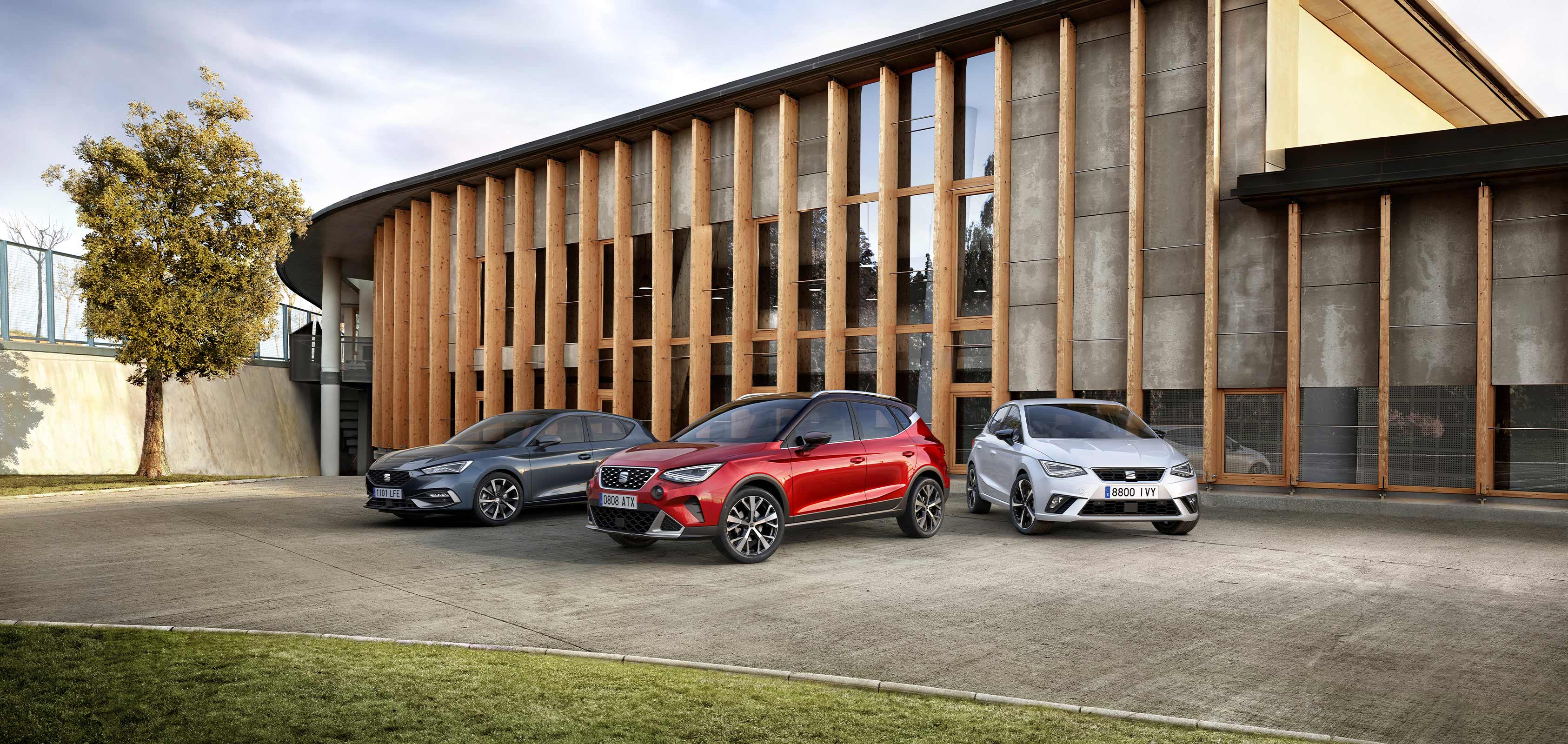 een seat leon seat arona en seat ibiza staan mooi opgesteld voor een kantoorgebouw